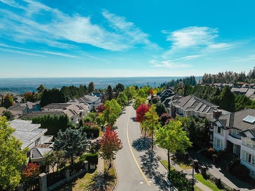 Coquitlam road surrounded by houses and greenery.