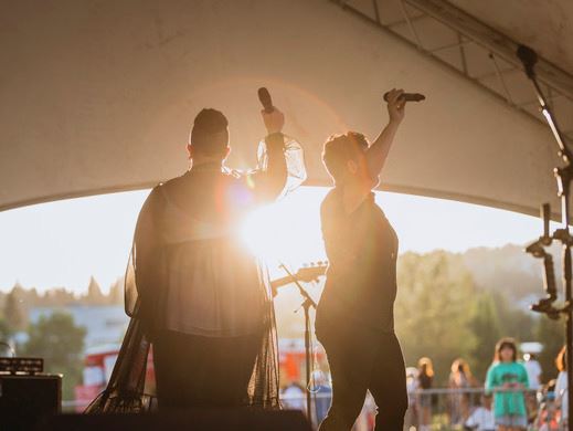 Two performers on stage in shadow