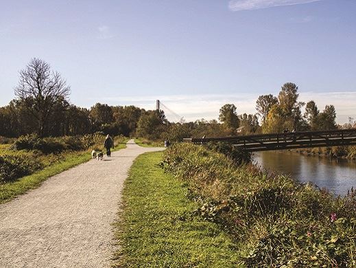 Park trail beside river and bridge