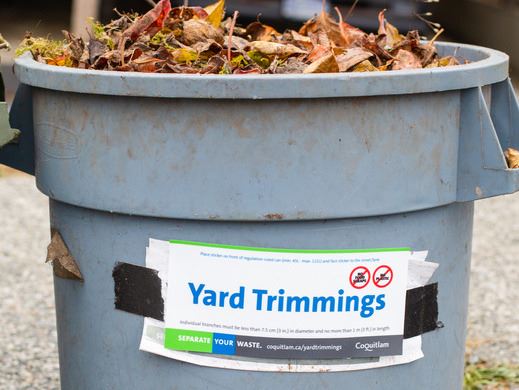 Garbage can with yard trimmings sticker