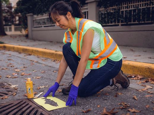 Women marking a storm drain