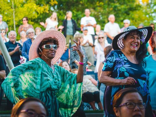 People at event laughing and enjoying a concert