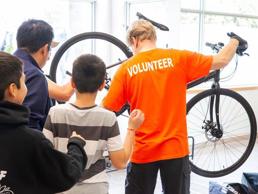 Volunteer assisting residents with bike repairs