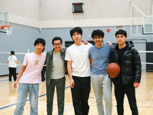 Youth standing in a gymnasium with a basketball