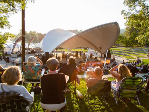 Summer Concert Series crowd in front of the stage with sunshine in the background 