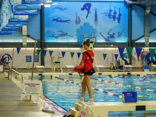 a female lifeguard walking along the side of CCAC's pool