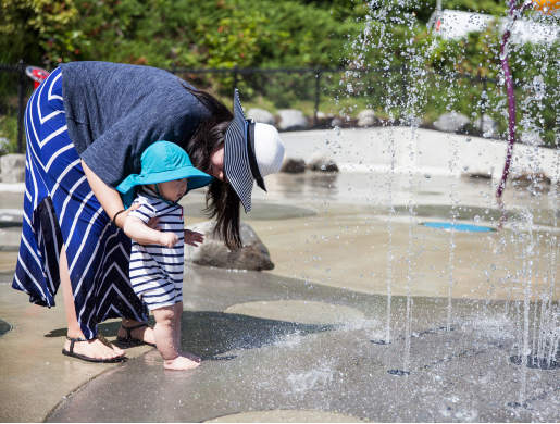 Adult and child at the spray park