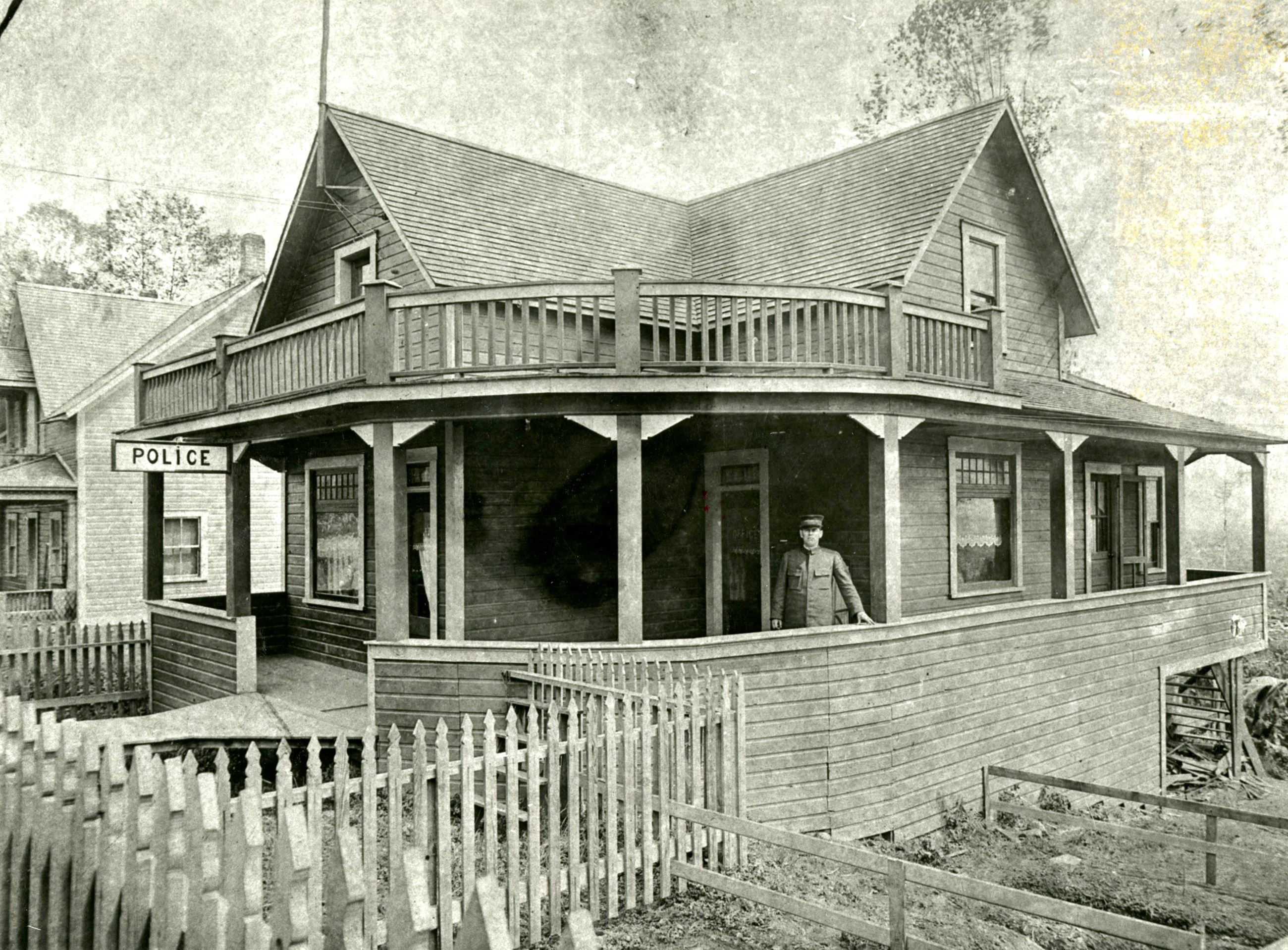 Photo of Police Station at 1318 Brunette Avenue with Emeri Pare on Porch in year 1919